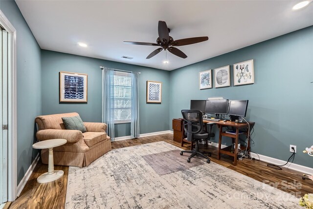 office space with visible vents, baseboards, and wood finished floors