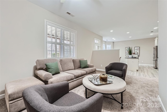 living area featuring visible vents, recessed lighting, light wood-style flooring, and baseboards