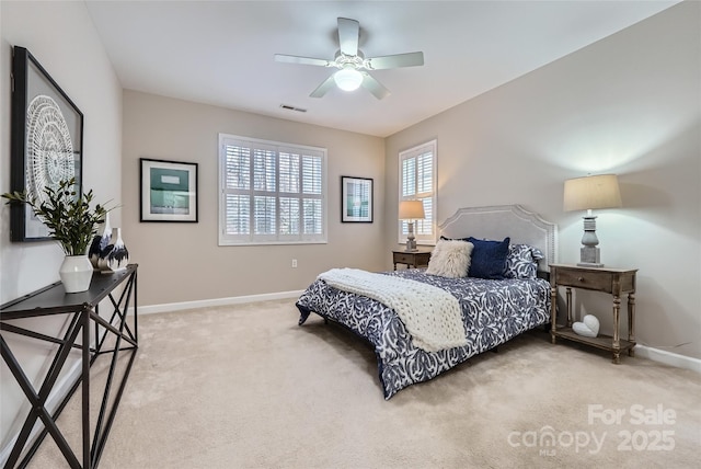 carpeted bedroom with visible vents, ceiling fan, and baseboards