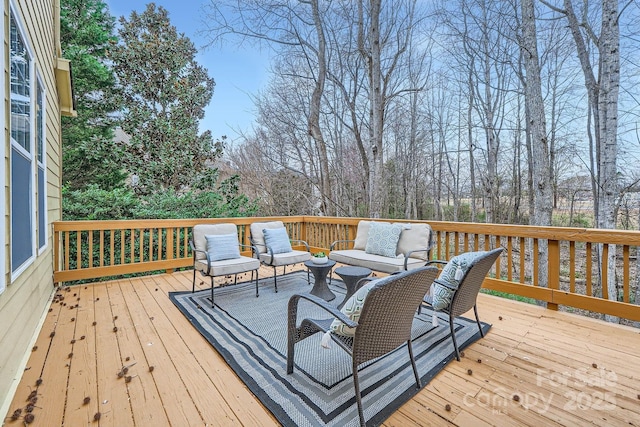 wooden terrace with an outdoor living space