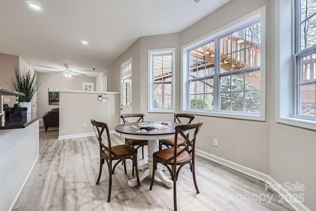 dining room with light wood-style flooring, recessed lighting, and baseboards