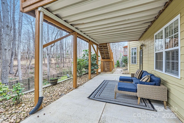 view of patio / terrace featuring stairs, an outdoor living space, and fence