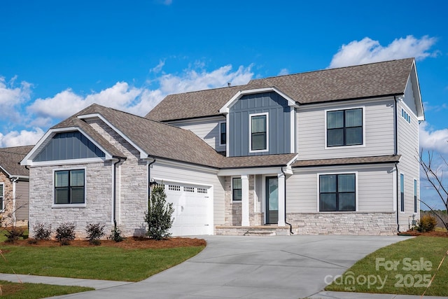 view of front of property with a shingled roof, concrete driveway, stone siding, an attached garage, and board and batten siding