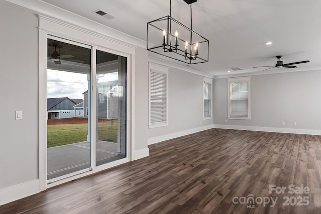 empty room featuring ornamental molding, visible vents, baseboards, and dark wood-style floors