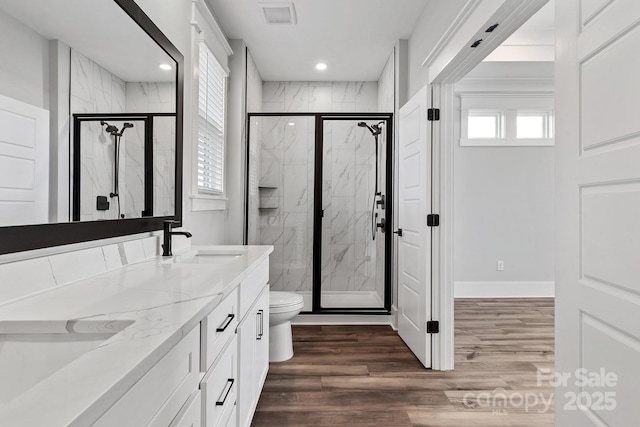 full bathroom featuring visible vents, a marble finish shower, and wood finished floors