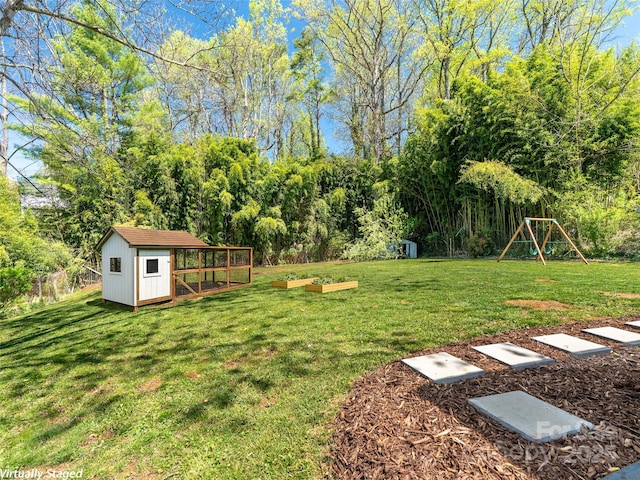view of yard with a storage unit, a playground, and an outdoor structure