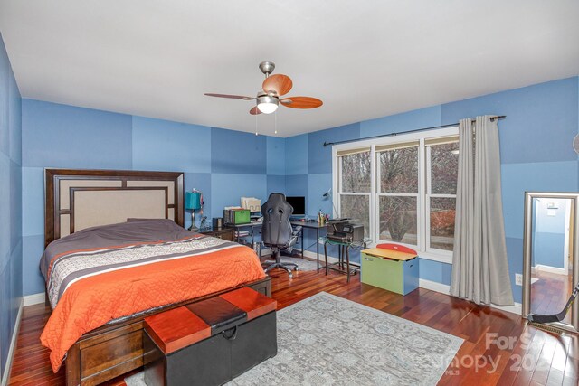 bedroom with hardwood / wood-style floors, baseboards, and ceiling fan