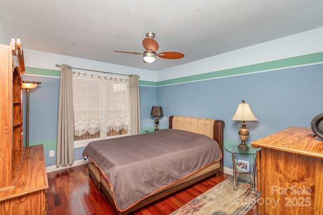 bedroom with a ceiling fan, baseboards, and wood finished floors