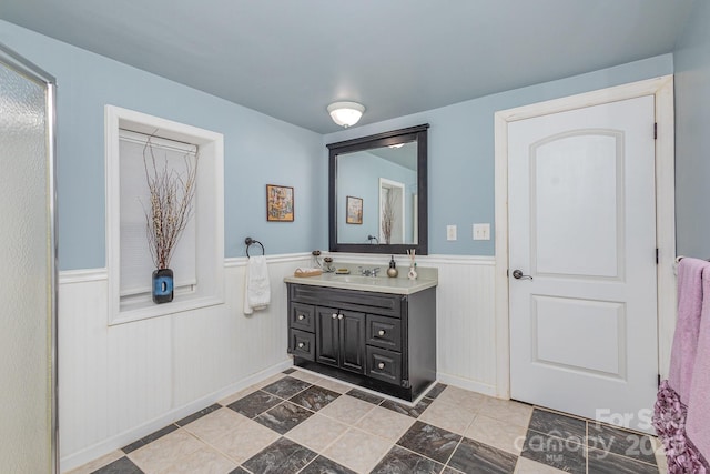 bathroom featuring vanity and a wainscoted wall