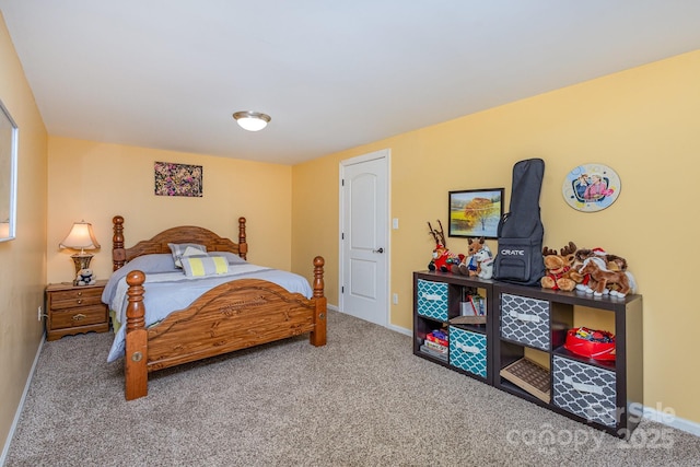 bedroom with baseboards and carpet