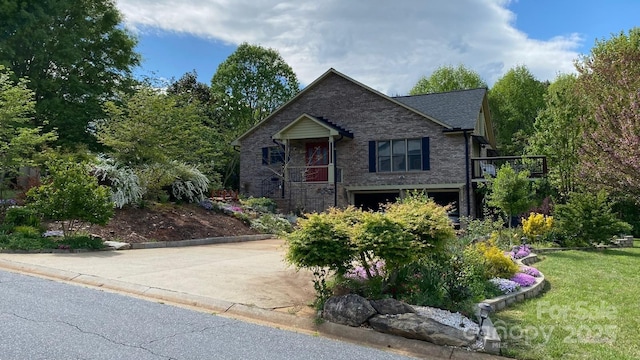 view of front of house with brick siding, driveway, a front yard, and a garage