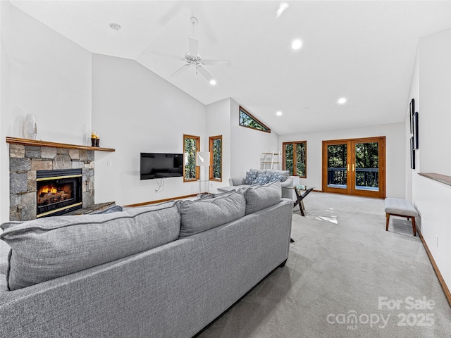 living room with ceiling fan, a fireplace, baseboards, and carpet flooring