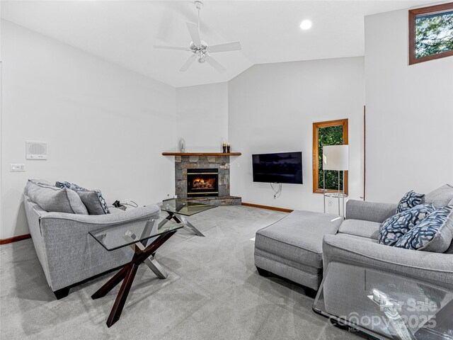 carpeted living area featuring baseboards, a ceiling fan, lofted ceiling, a fireplace, and recessed lighting