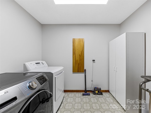 laundry area with light floors, cabinet space, independent washer and dryer, and baseboards