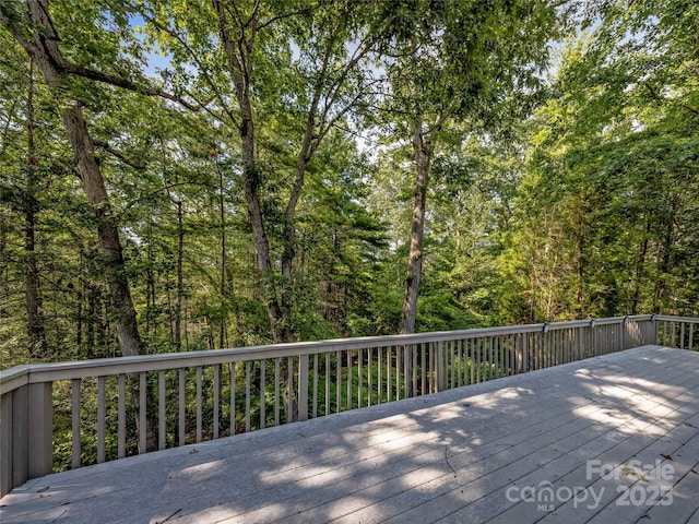 wooden deck with a forest view