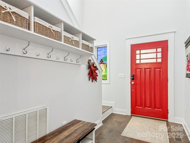 mudroom with baseboards, visible vents, and dark wood finished floors