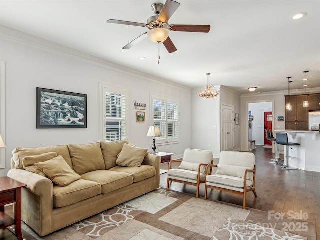 living room featuring crown molding, recessed lighting, dark wood finished floors, and baseboards