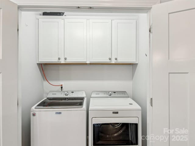 washroom with cabinet space and separate washer and dryer