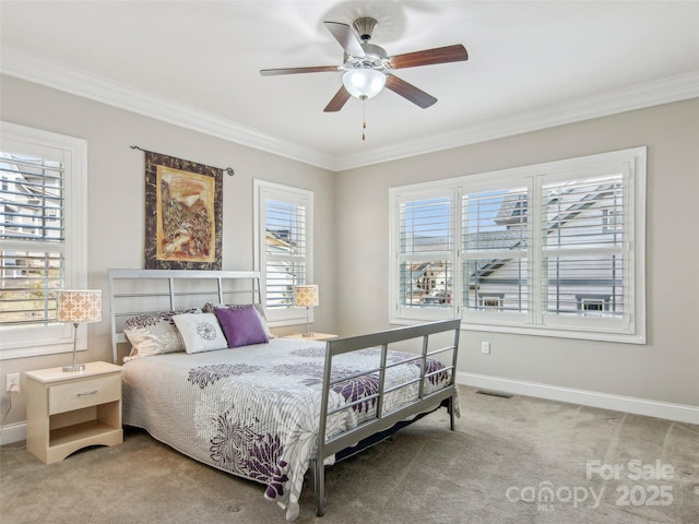 bedroom featuring crown molding, baseboards, and carpet flooring