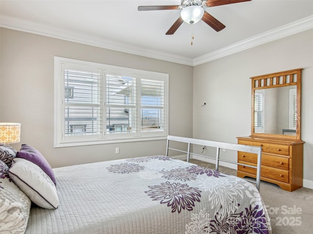 bedroom with baseboards, carpet, ornamental molding, and a ceiling fan