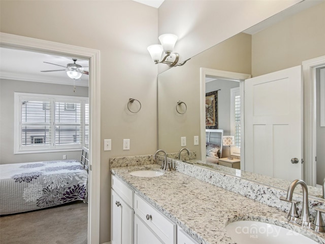 ensuite bathroom featuring a sink, double vanity, ceiling fan, and ensuite bath