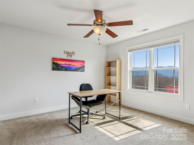 office featuring carpet floors, baseboards, and a ceiling fan