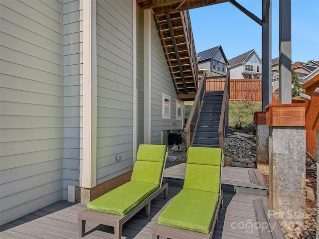 deck featuring stairs and fence