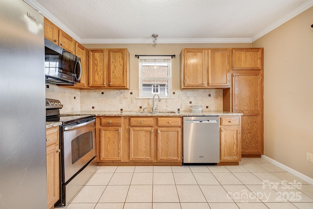 kitchen with decorative backsplash, stainless steel appliances, crown molding, and a sink