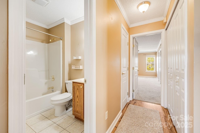 full bath featuring visible vents, a textured ceiling, vanity, and toilet