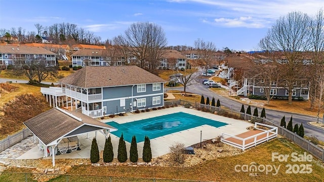 rear view of house with a fenced backyard and a residential view