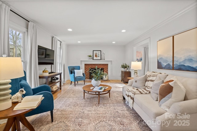 living area with a fireplace, wood finished floors, and recessed lighting