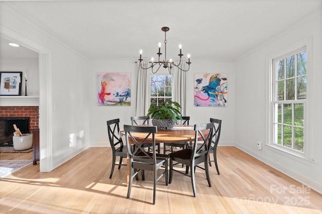 dining space with ornamental molding, a wealth of natural light, and light wood-style flooring