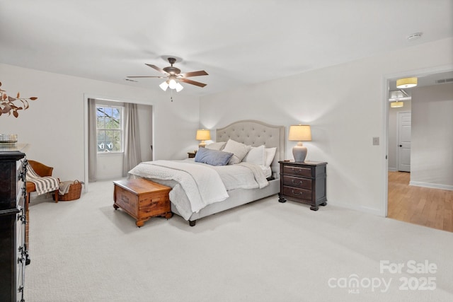 bedroom with a ceiling fan, carpet, and baseboards