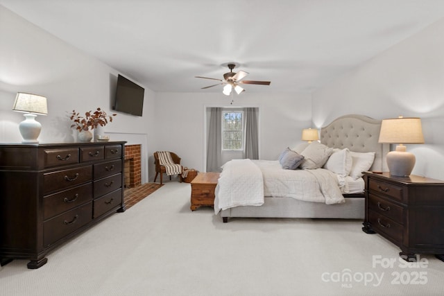 bedroom featuring light carpet and a ceiling fan