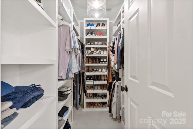 walk in closet featuring carpet and visible vents