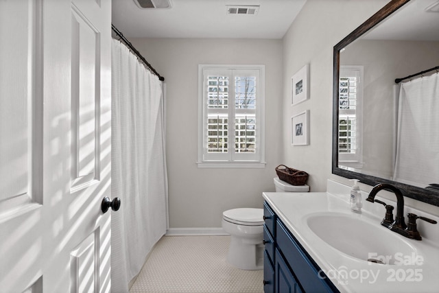 bathroom featuring toilet, baseboards, visible vents, and vanity