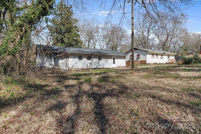 back of house featuring a lawn