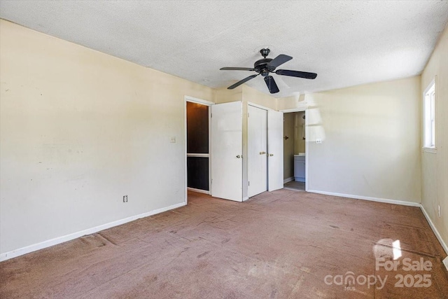 unfurnished bedroom with baseboards, a textured ceiling, ceiling fan, and carpet