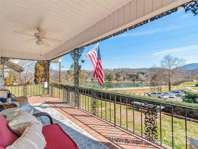 view of patio featuring a water view and ceiling fan