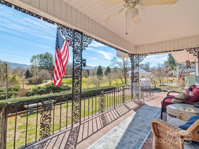 exterior space featuring ceiling fan and a mountain view