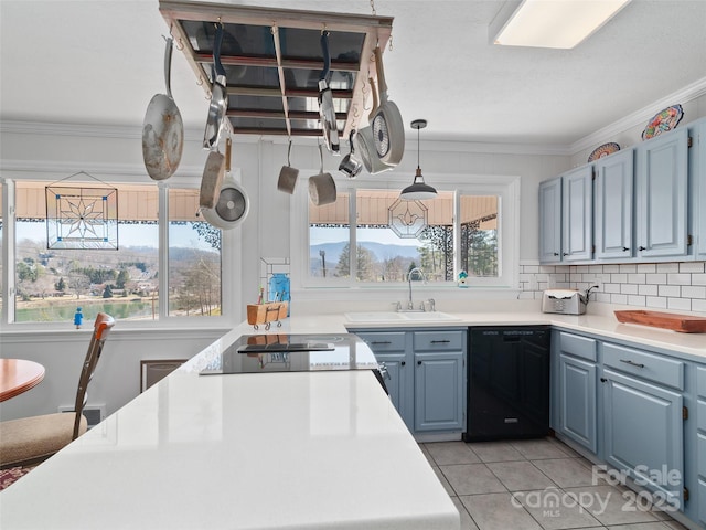 kitchen featuring crown molding, light countertops, dishwasher, and light tile patterned floors