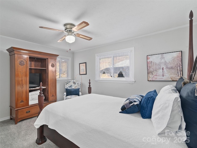 bedroom with ornamental molding, light colored carpet, ceiling fan, and baseboards