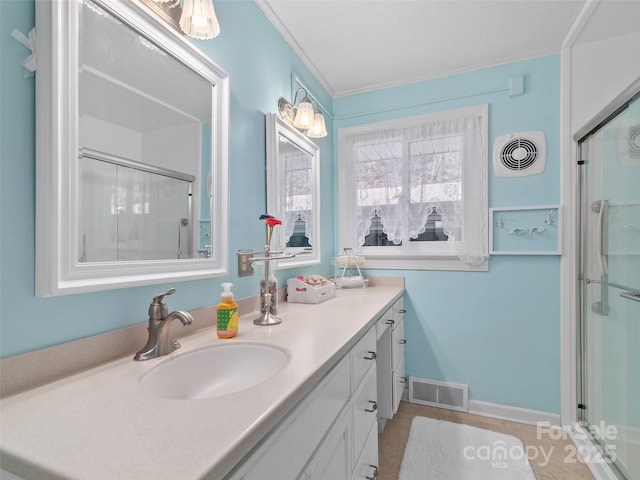 full bathroom featuring a stall shower, visible vents, and vanity