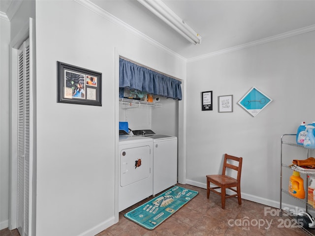 clothes washing area featuring ornamental molding, laundry area, separate washer and dryer, and baseboards