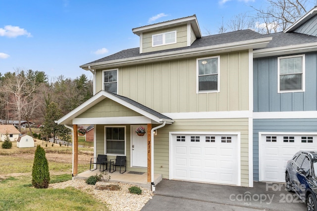 view of front of house with a garage, a porch, roof with shingles, and aphalt driveway