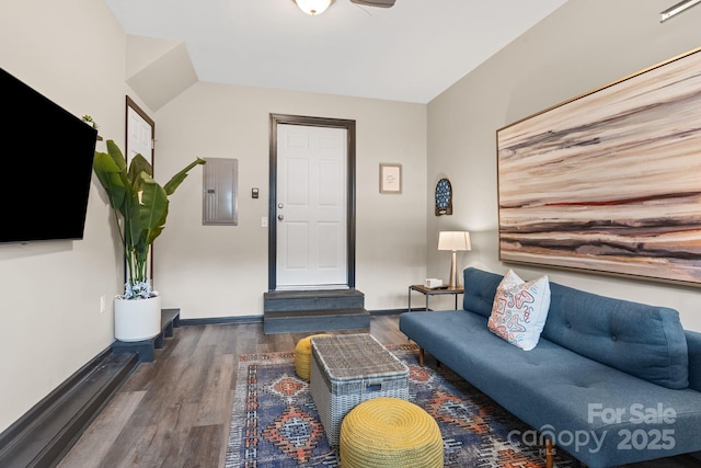 living room with electric panel, baseboards, and wood finished floors