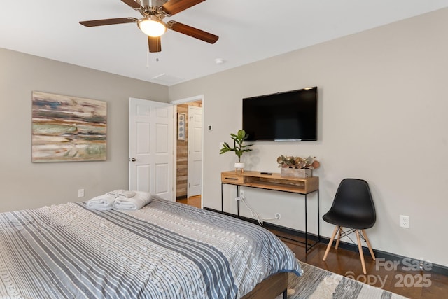 bedroom featuring ceiling fan, baseboards, and wood finished floors