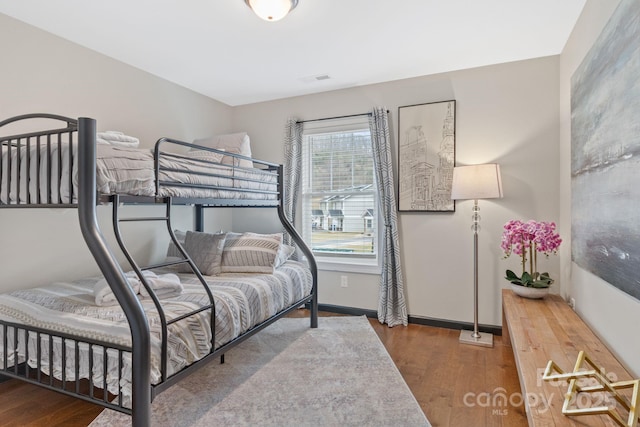 bedroom featuring wood finished floors and baseboards