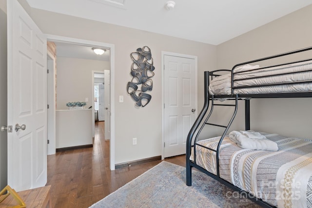 bedroom featuring baseboards and wood finished floors