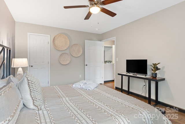 bedroom featuring ceiling fan, wood finished floors, and baseboards